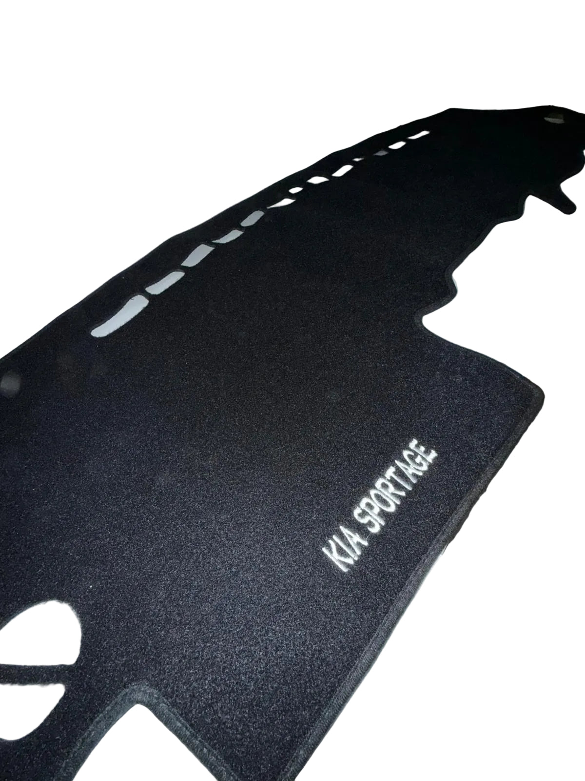 Black car mat with 'KIA SPORTAGE' branding on a white surface