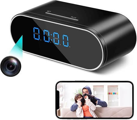 Black digital clock with camera and smartphone display showing a video call.