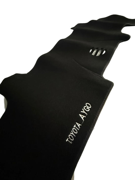 Black car mat with 'TOYOTA AYGO' branding on a white surface.