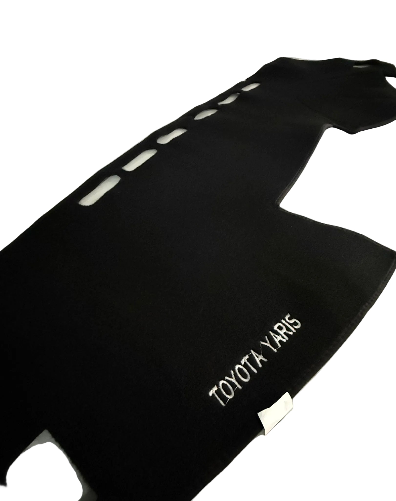 Black car mat with 'TOYOTA YARIS' branding on a white surface.
