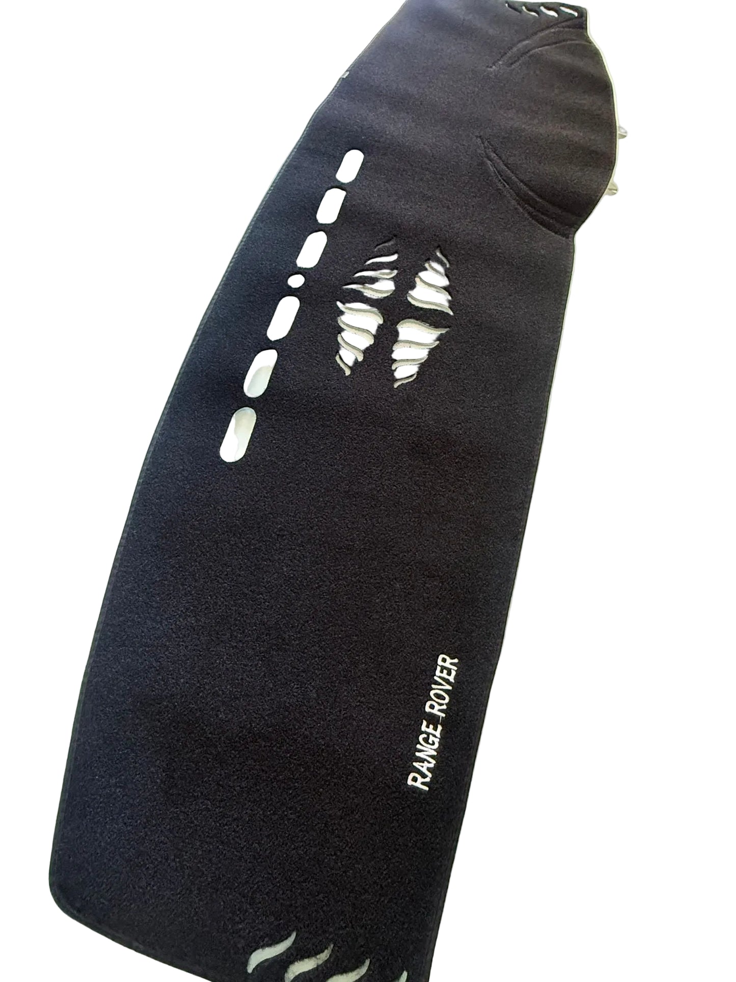 Black mat with cut-out patterns on a glass surface