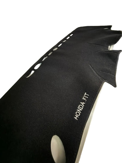 Black car mat with 'Honda Fit' branding on a vehicle interior.