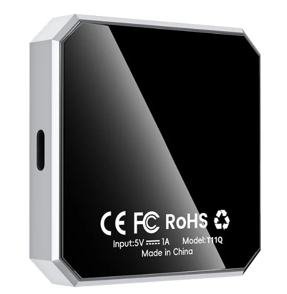 A square electronic device with a glossy black faceplate and a silver metallic frame, featuring white text with CE, FC, RoHS, and other specifications on the front.