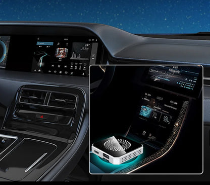A car interior dashboard and center console are shown, with an inset close-up highlighting a small white rectangular device placed on the console. The device has a circular vent-like top and glowing blue LED lighting around it, suggesting an automotive accessory or console organizer.